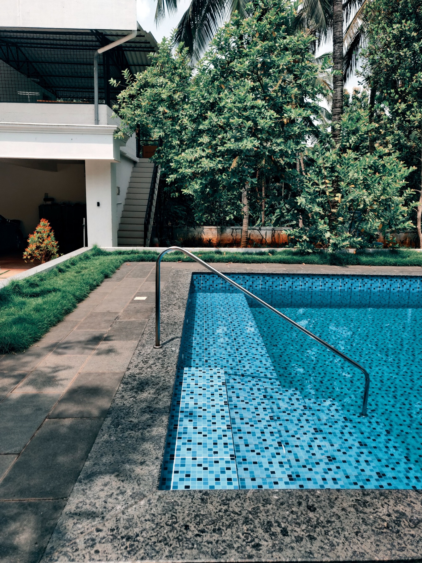 Tropical pool with mosaic tile steps